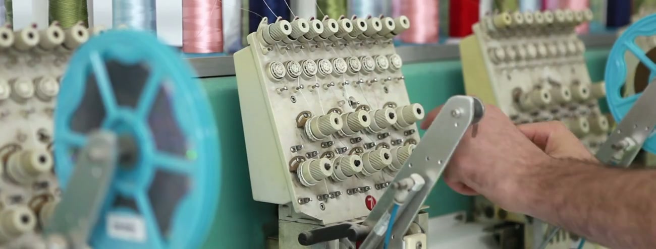 Close-up of a multi-thread industrial stitching machine in operation